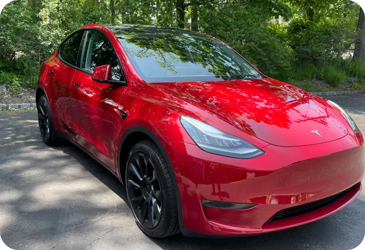 Shiny red sedan in sunlight
